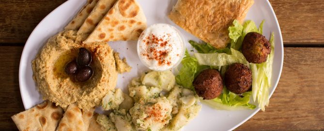 A mezze (appetizer) platter consisting of hummus, pita and falafels.